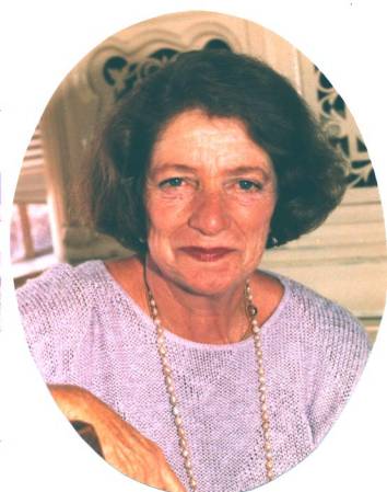 A woman with dark brown hair smiles warmly at the camera